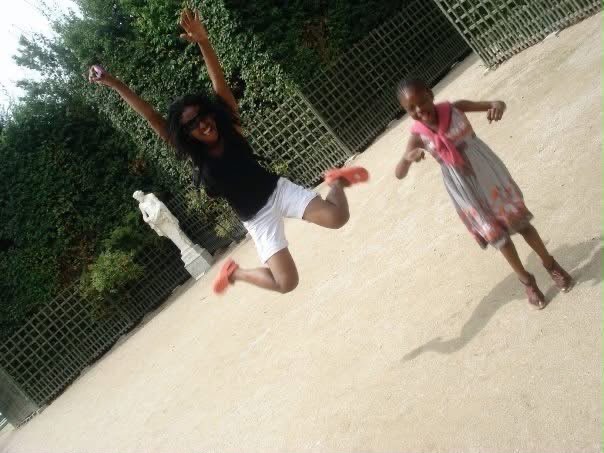 Two family members jumping and smiling together outdoors