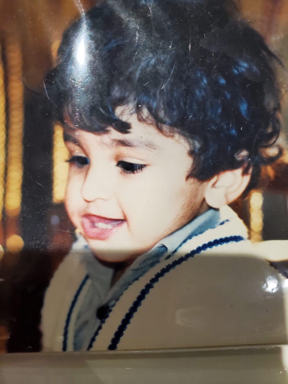 A childhood portrait of Usman smiling